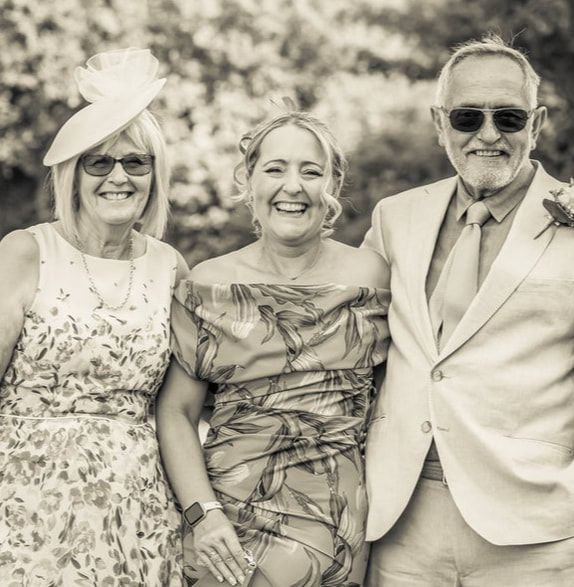 A series of black and white photographs showing people sitting outdoors and smiling together on a sunny day.