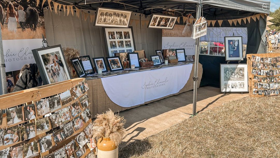 A rustic wooden wall covered in vintage photographs, signs, and memorabilia creating a nostalgic display.