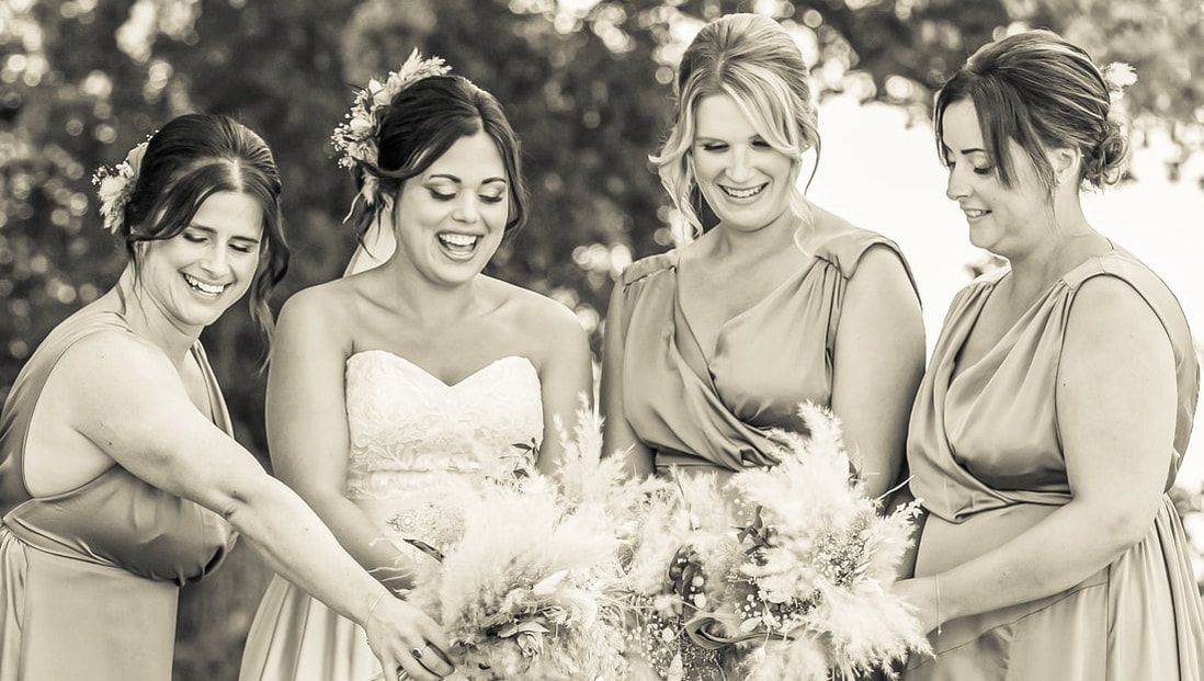 A black and white collage of wedding party moments showing laughter and candid interactions outdoors.