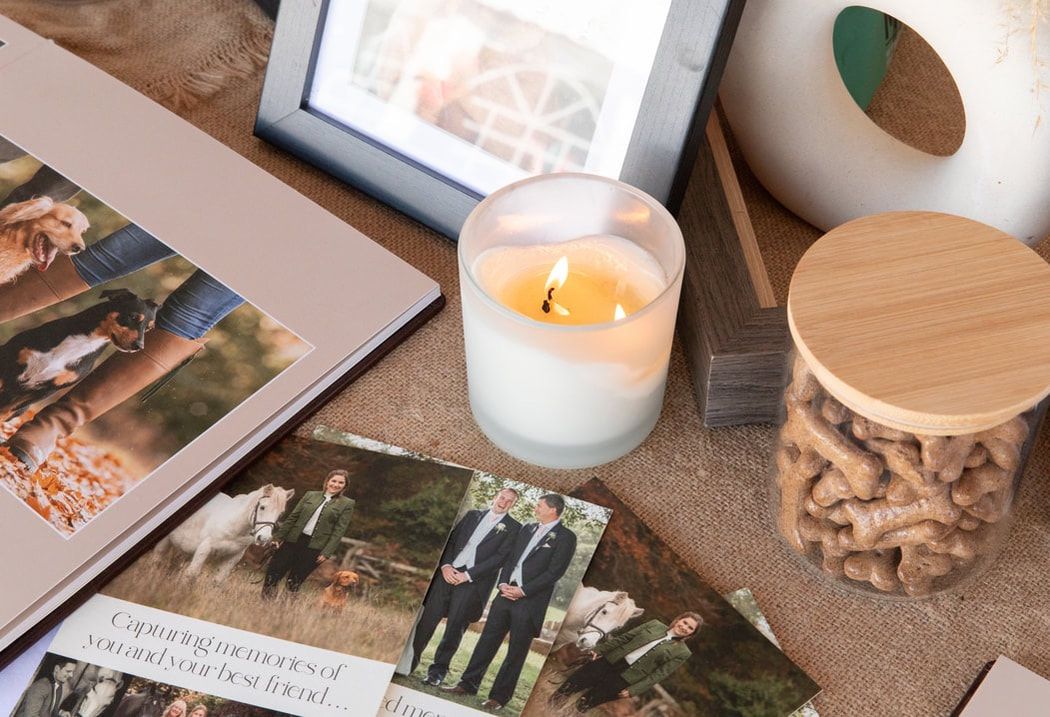 A collection of photographs and personal mementos arranged in a grid layout with candles and decorative items.