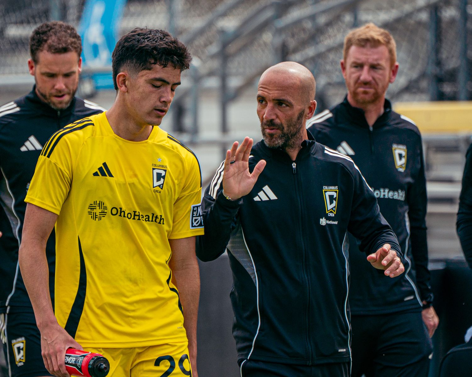 Soccer coaches giving instruction to a player