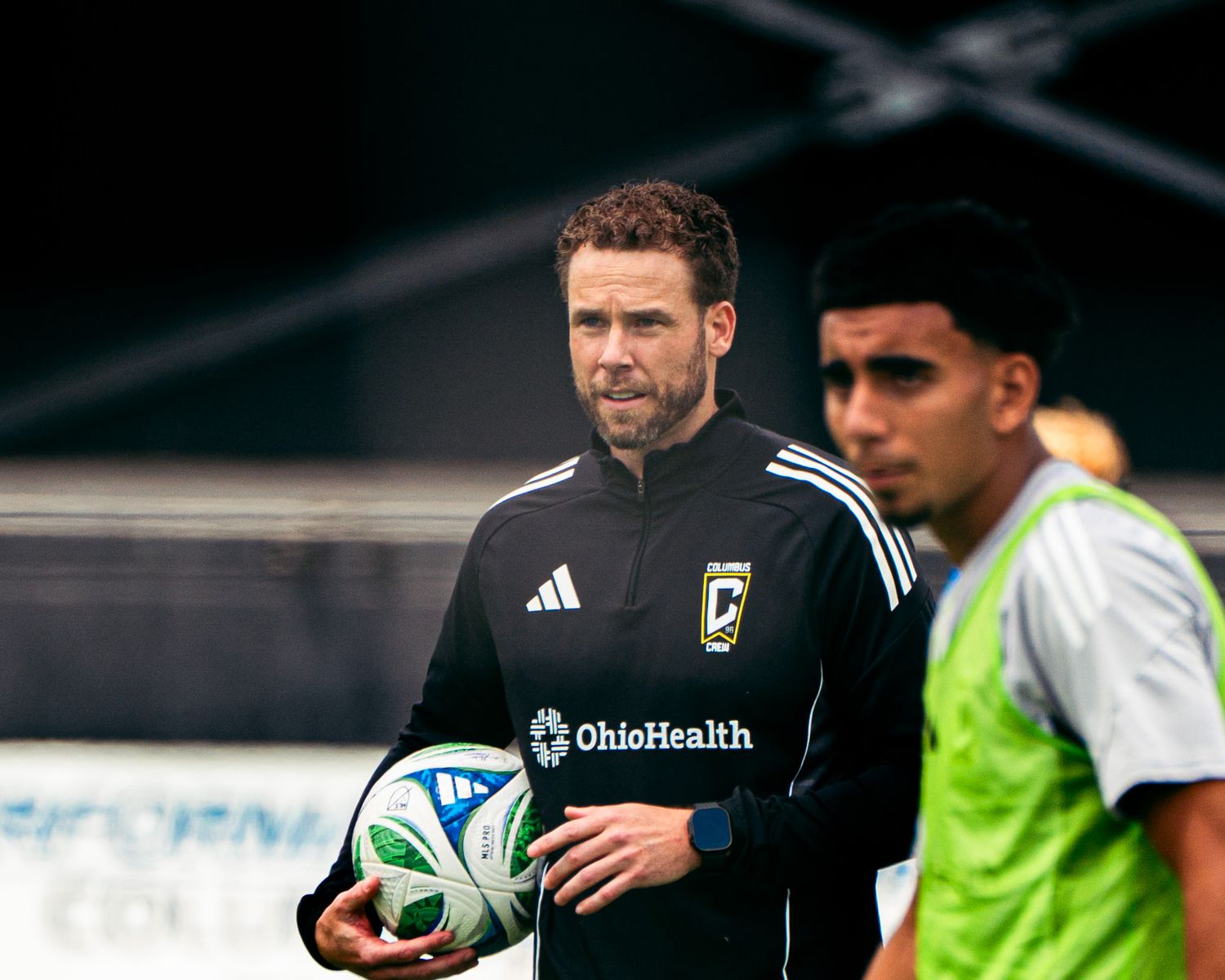 A soccer coach observing the action