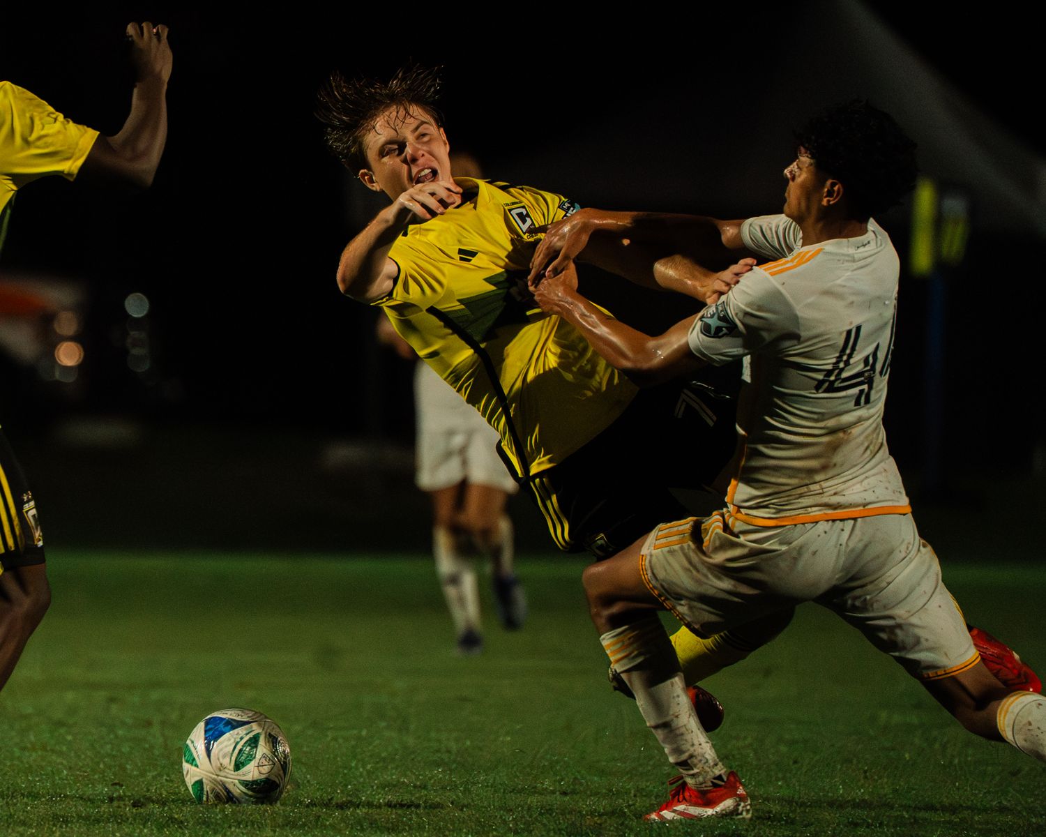 Soccer photo of a player being fouled