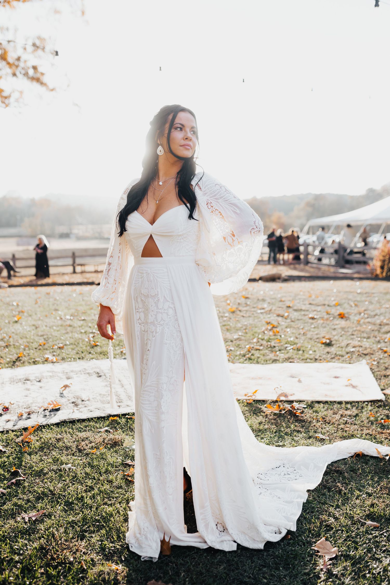 Ethereal white lace maxi dress flowing in the breeze during an outdoor photoshoot.
