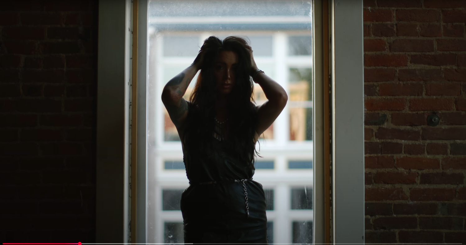 Dark silhouettes against window light create dramatic indoor portrait composition.