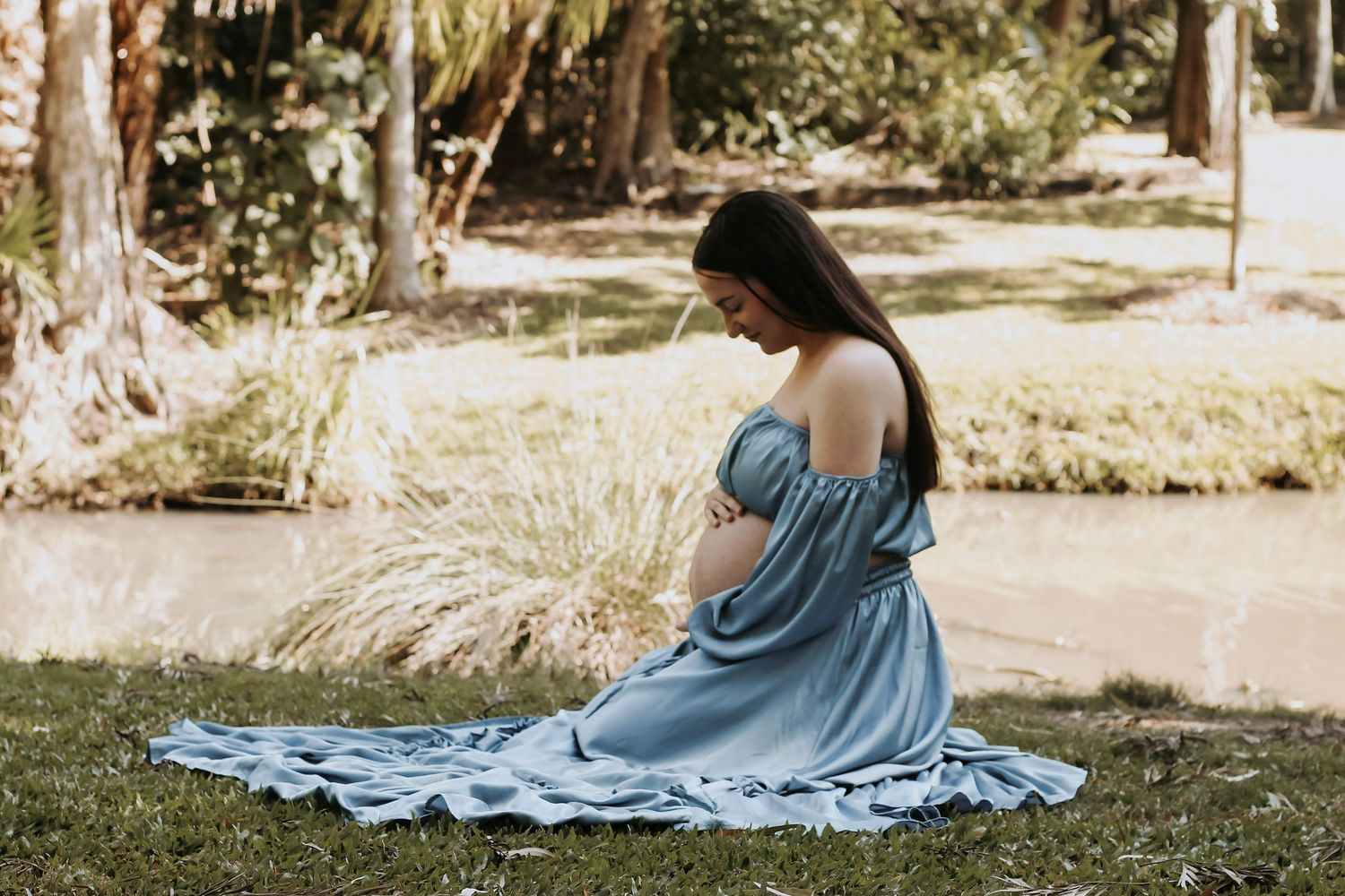 Mother cuddling her baby during a relaxed outdoor motherhood photography session in Hervey Bay.
