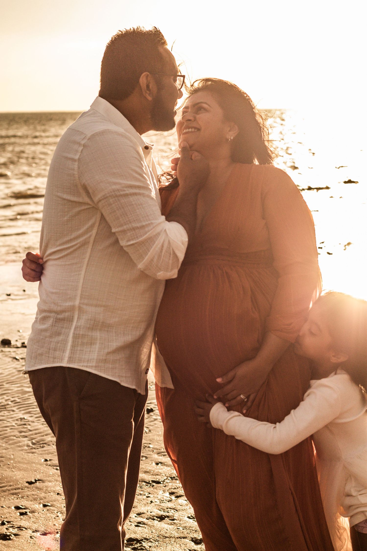 Celebrating this family's newest chapter at sunset on the beach in Hervey Bay