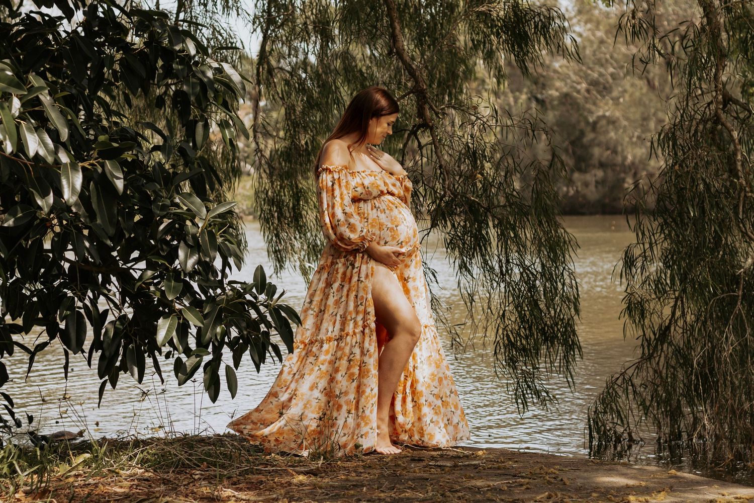 Pregnant mother Standing at the pond during a morning maternity photography session in Hervey Bay.