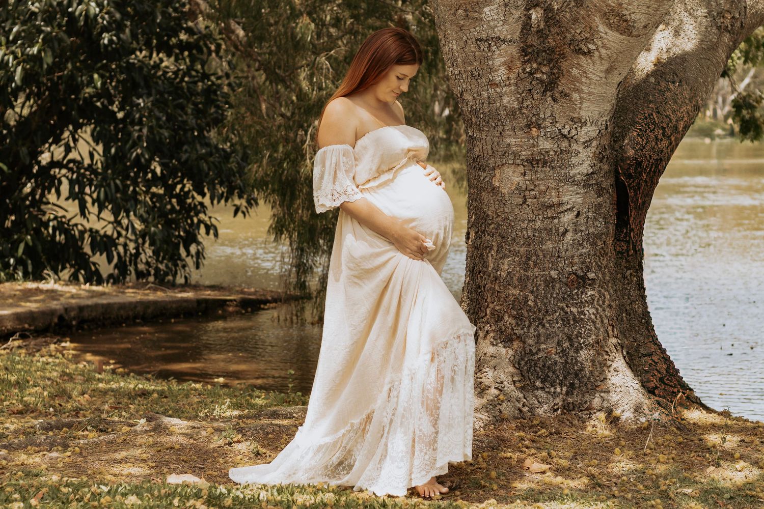 Pregnant mother Standing at the pond during a morning maternity photography session in Hervey Bay.