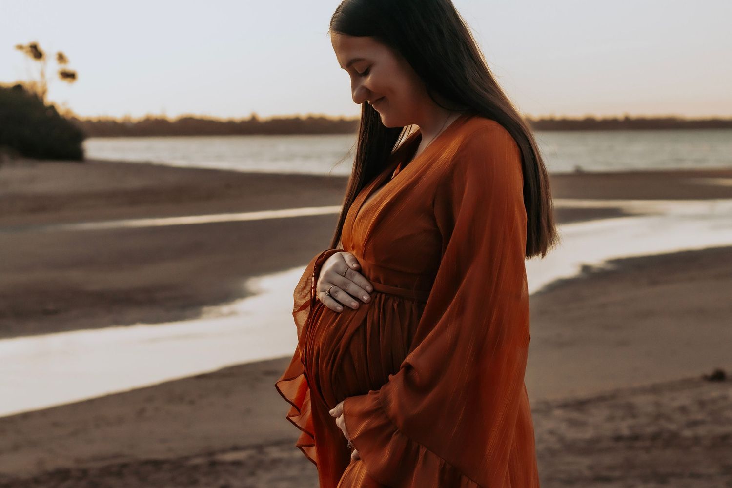 Expectant mother on the beach during a sunset maternity session