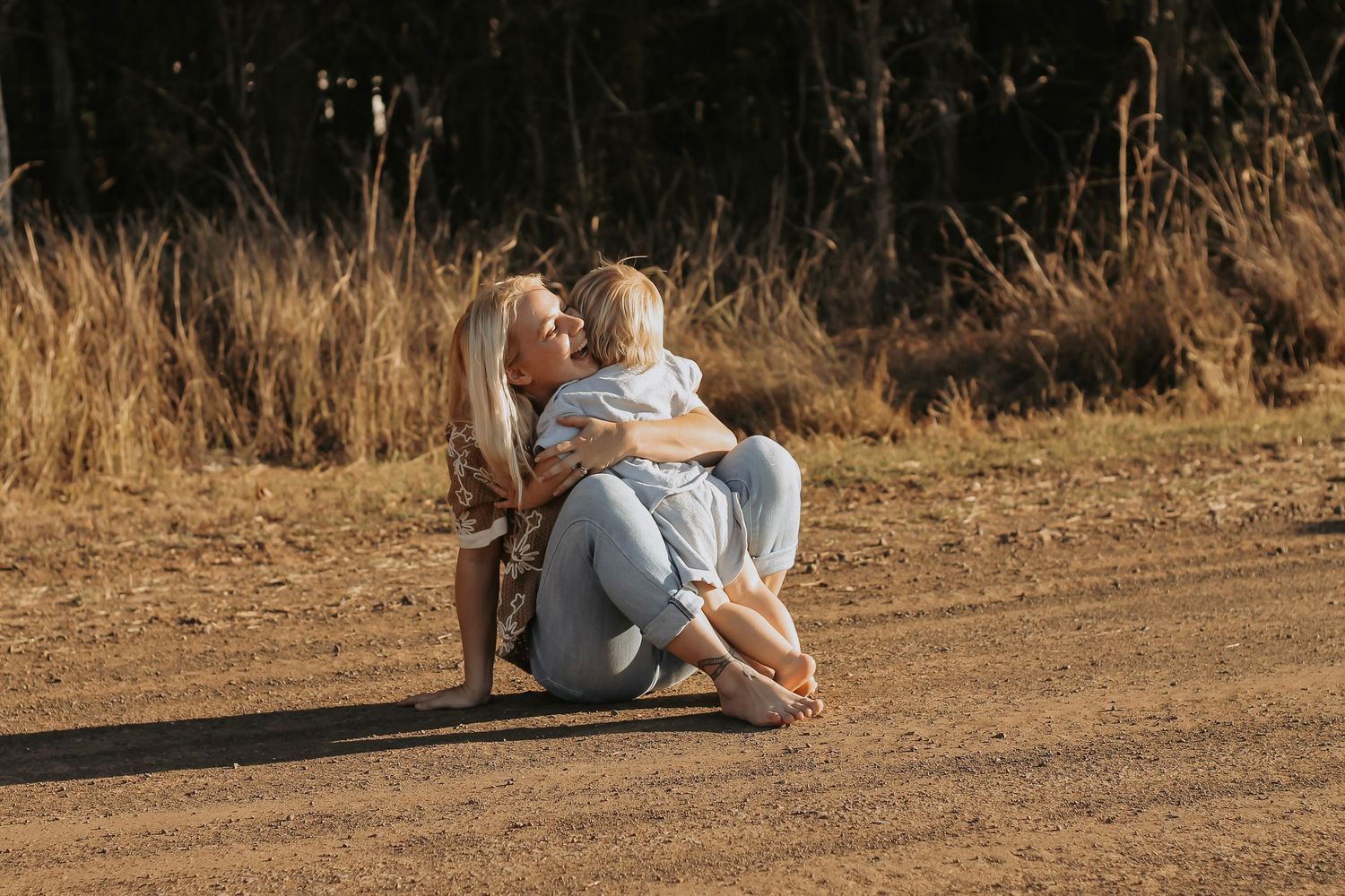 Mother cuddling her baby boy  during a relaxed outdoor motherhood photography session in Hervey Bay.