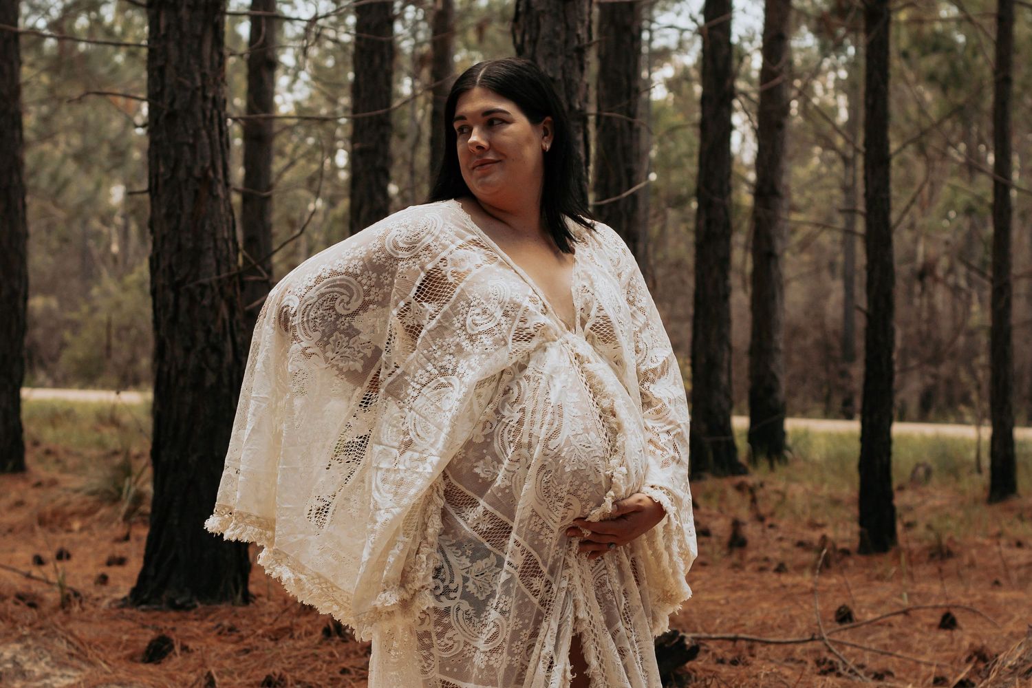 Pregnant mother standing in the Pine forest during a morning maternity photography session in Maryborough.