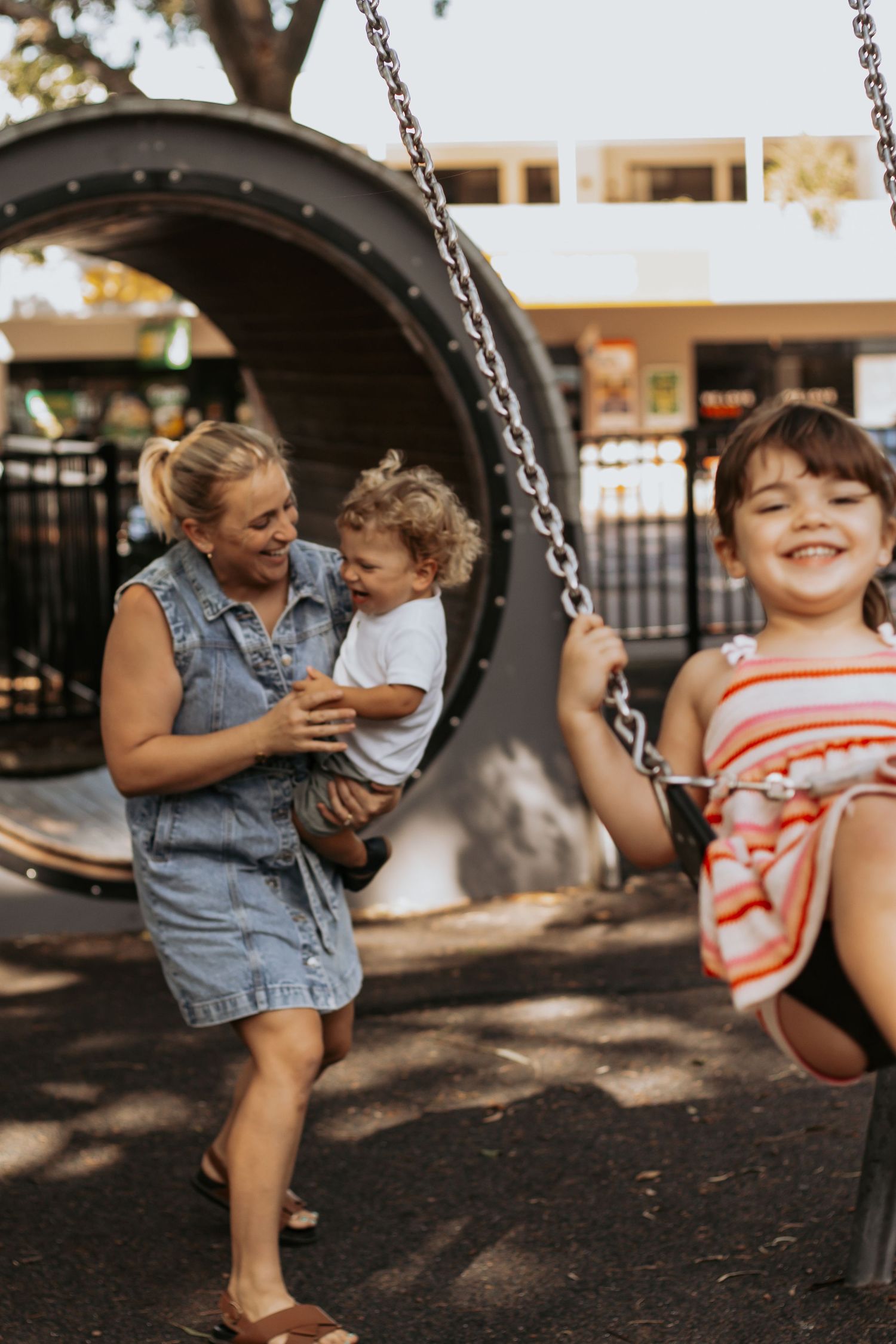 Mother and her two children enjoying a session at the park for a morning family session in Hervey Bay