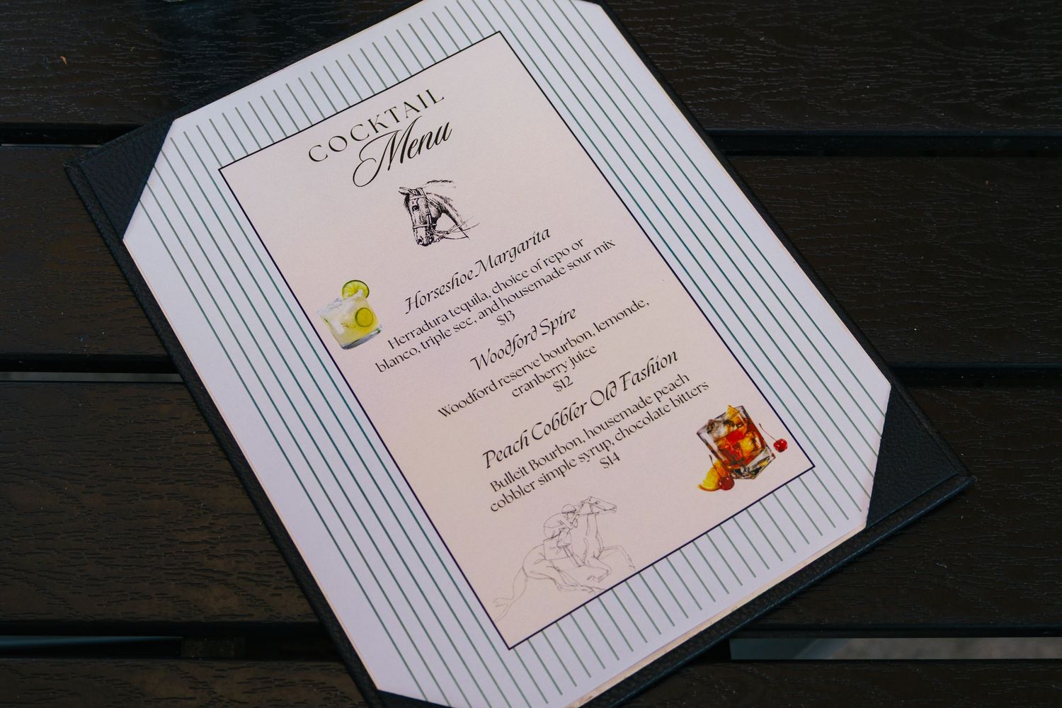 Elegant cocktail menu card with decorative border listing signature drinks for a special event.