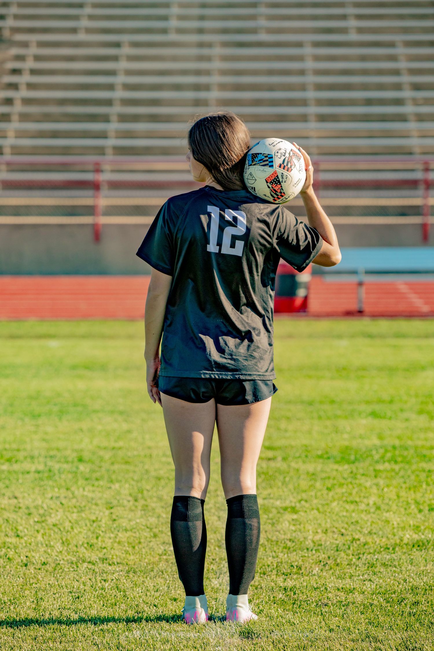 Soccer goalkeeper training sequence showing warm-up drills and ball handling on grass field with stadium bleachers.