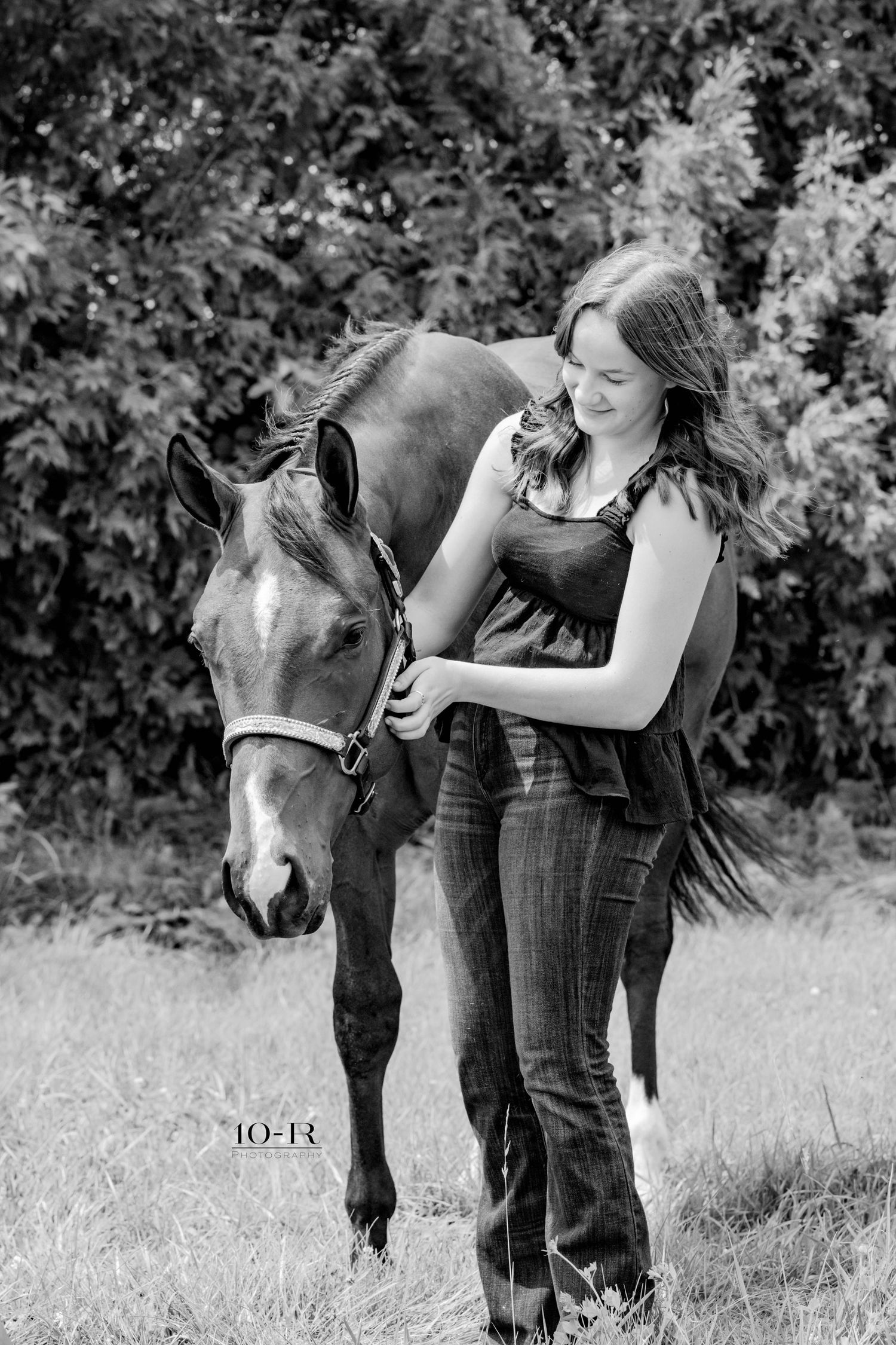 A series of black and white photos showing tender interactions between a person and a small horse in an outdoor setting.