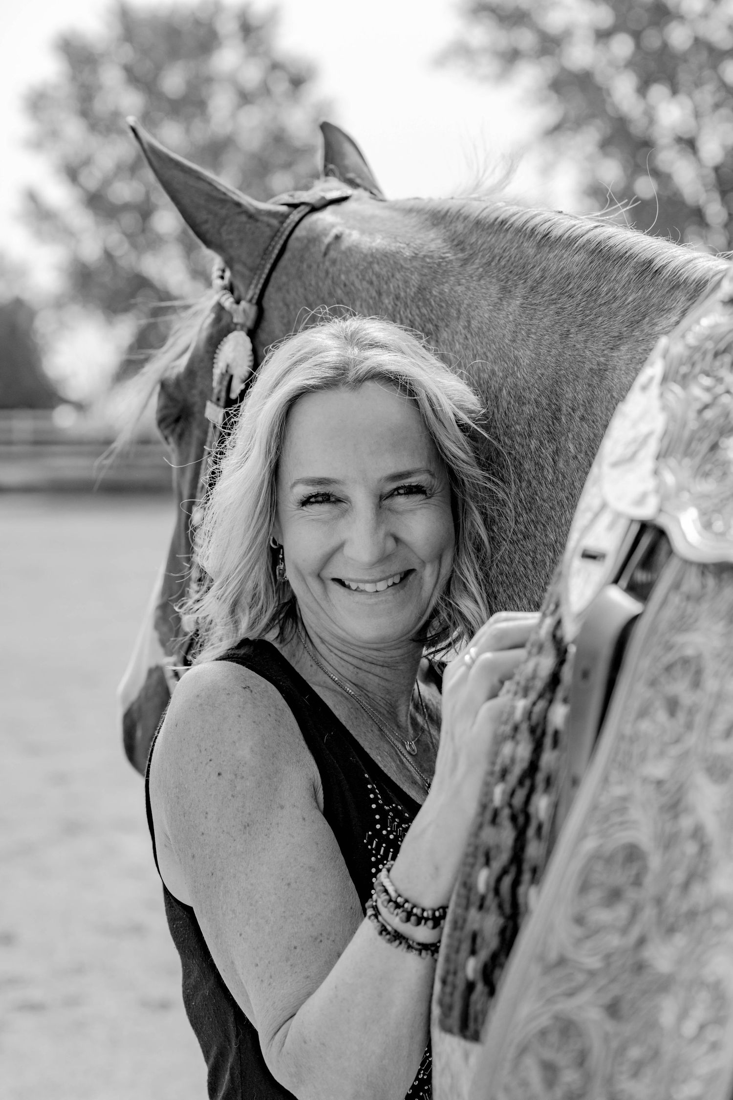 A series of black and white portraits showing close interactions with a horse in an outdoor setting.