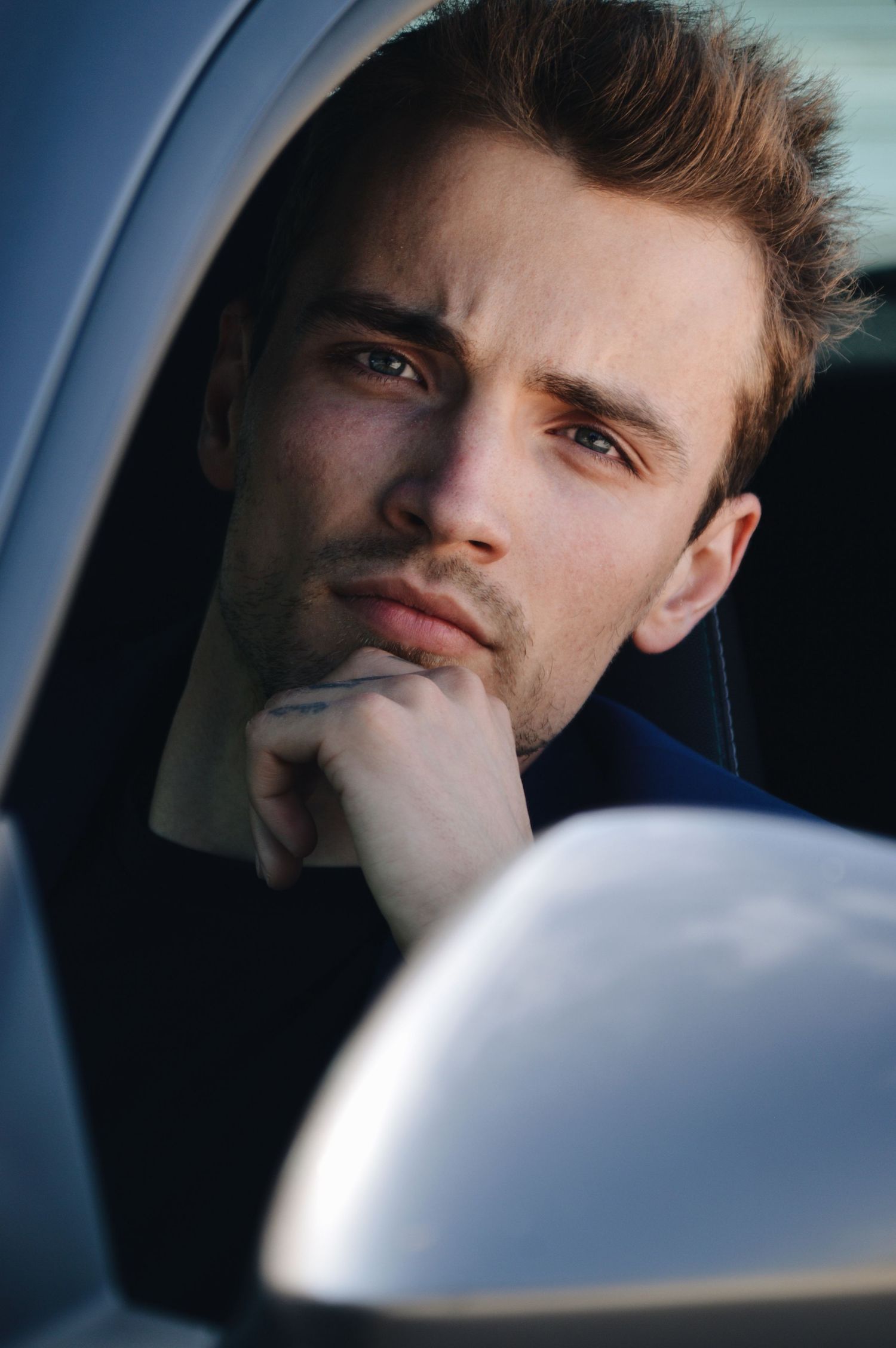 Close-up portrait series through car window with natural lighting.