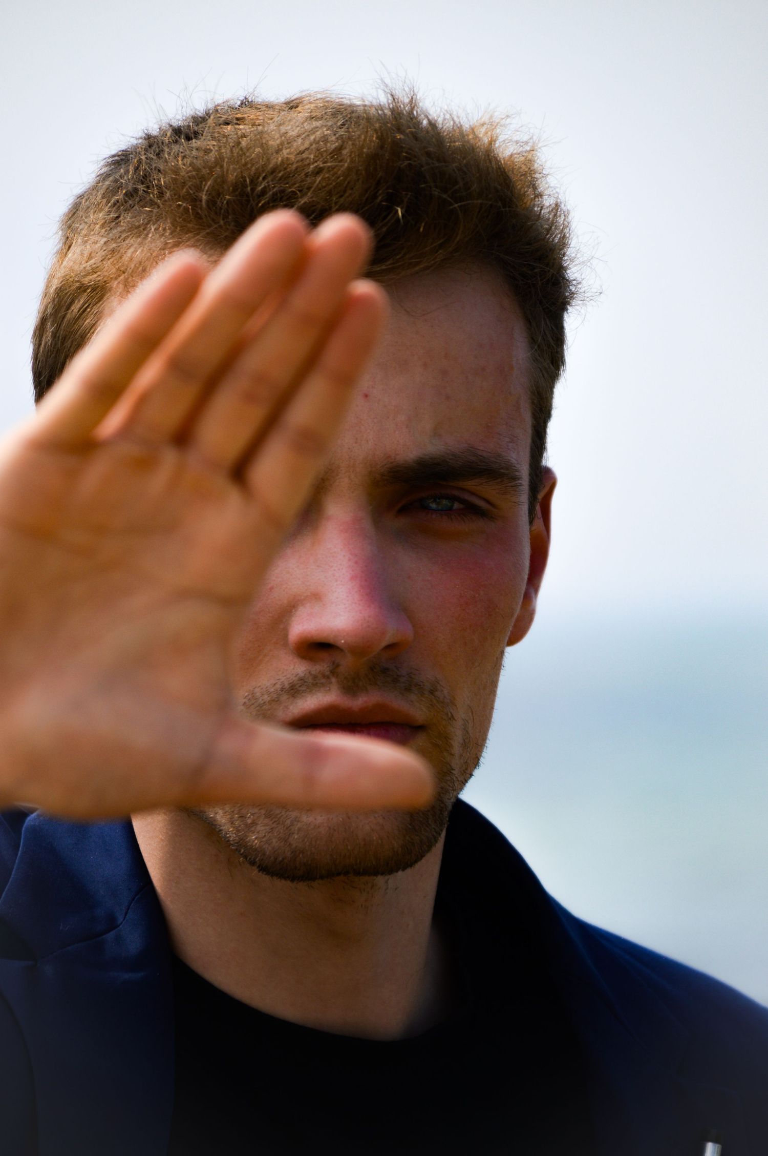 Person shielding eyes from sun in sequential black and white photos.