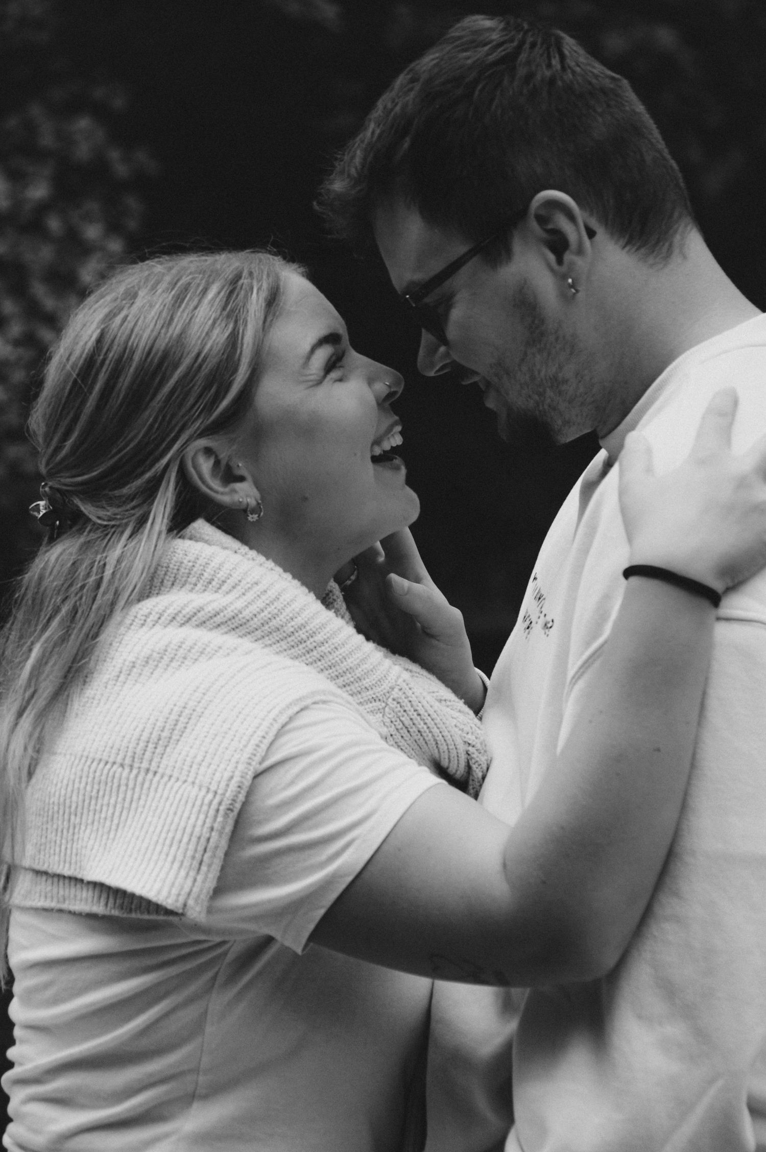 Intimate black and white portrait sequence showing couple's joyful interaction.