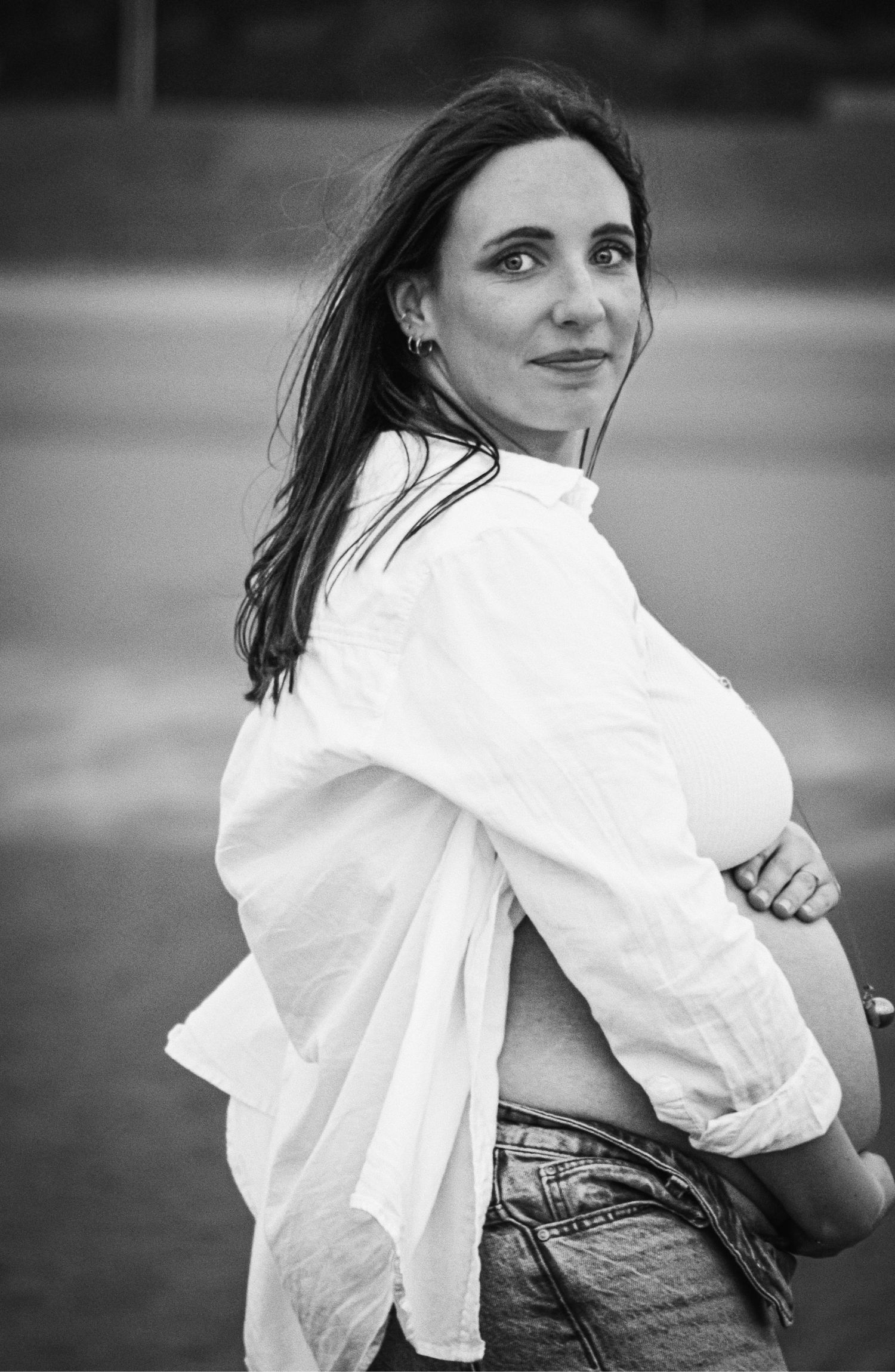 Dynamic black and white maternity photos with flowing white shirt and denim.