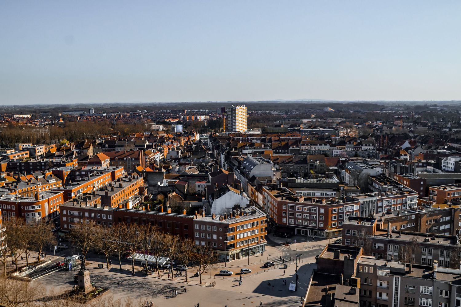 Panoramic cityscape view of urban buildings and streets during daytime.