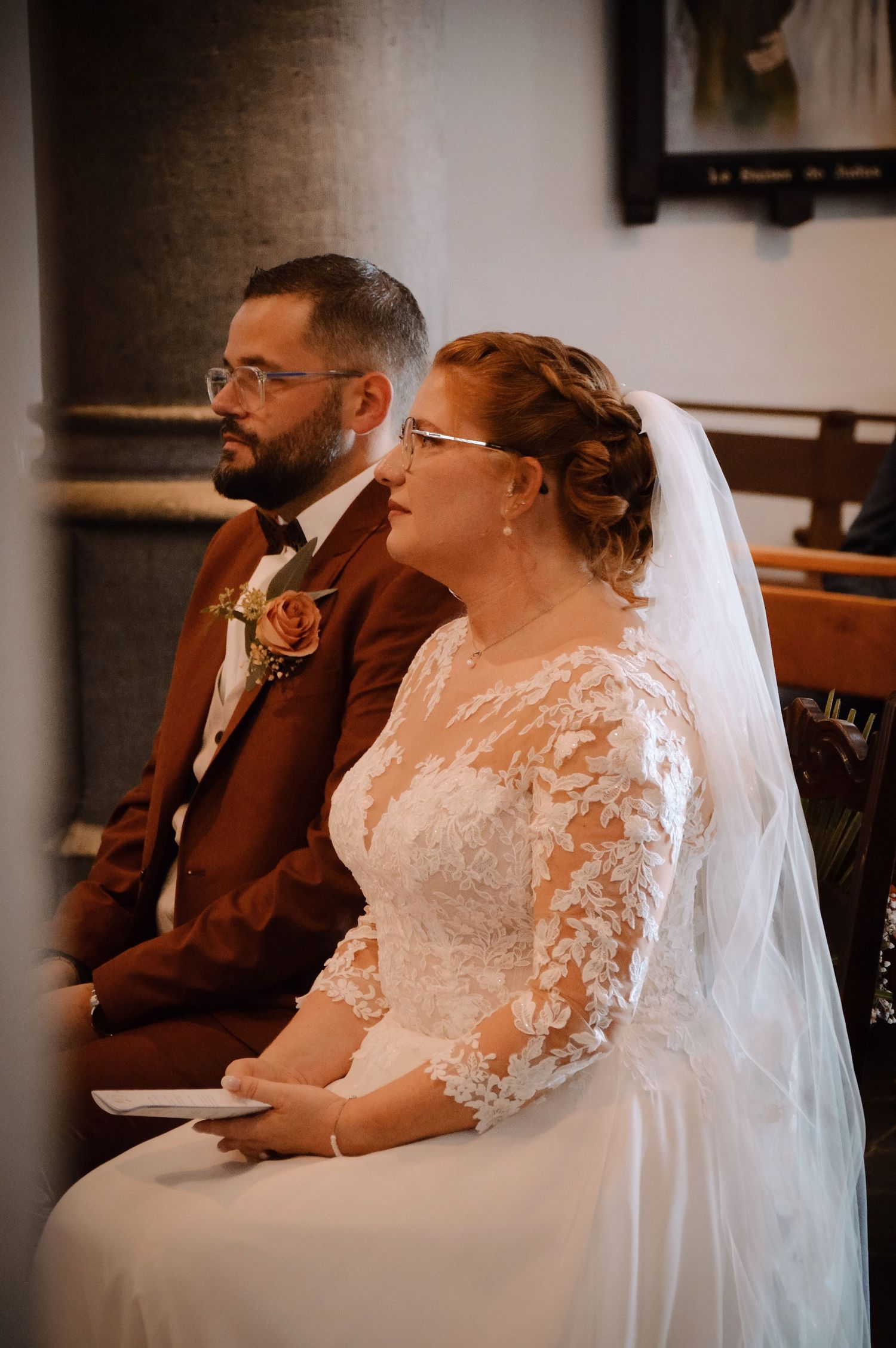 Couple sharing quiet moments during wedding ceremony in formal attire.