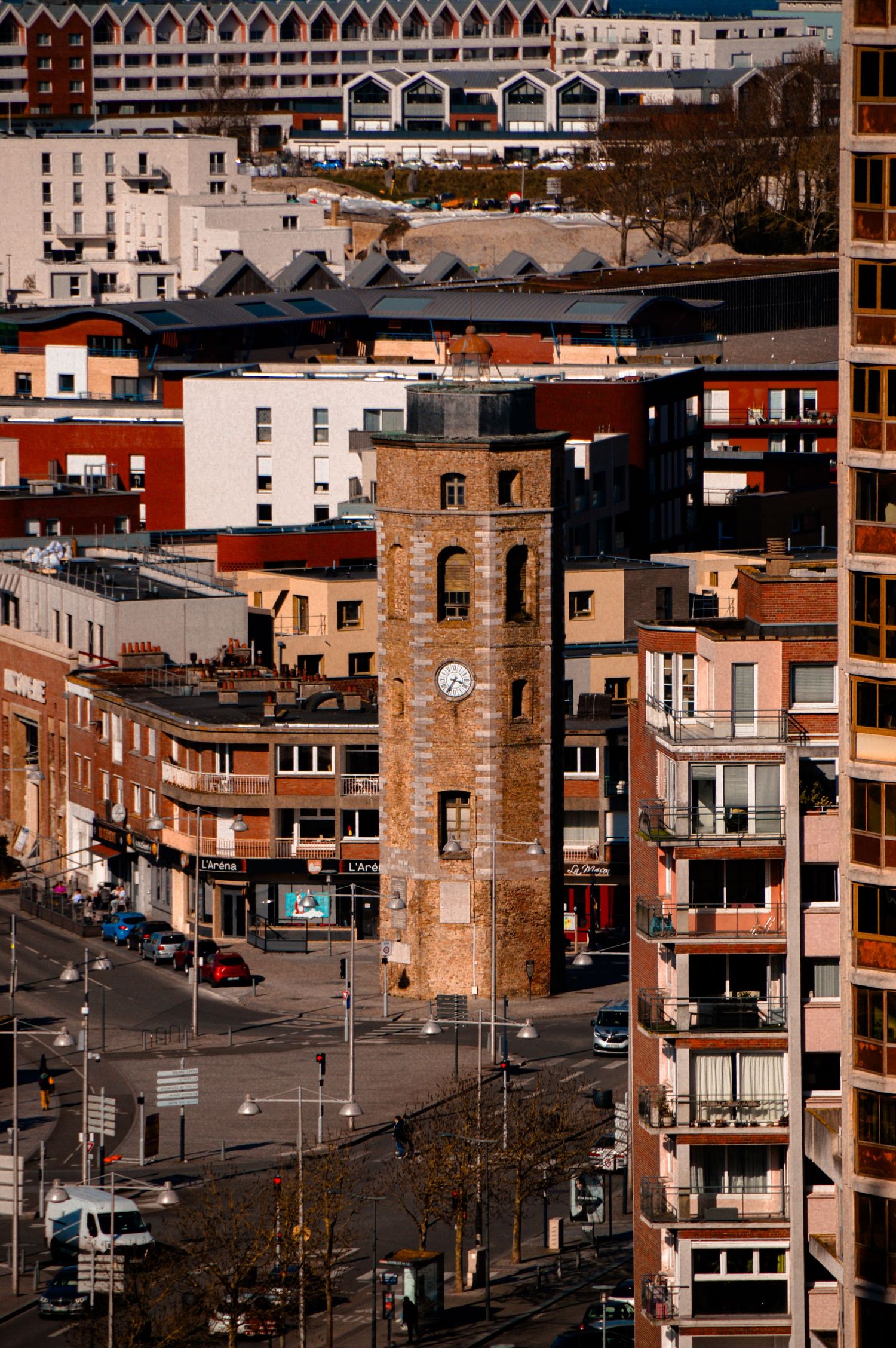 Aerial view of urban architecture showing brick buildings and rooftops in a city neighborhood.