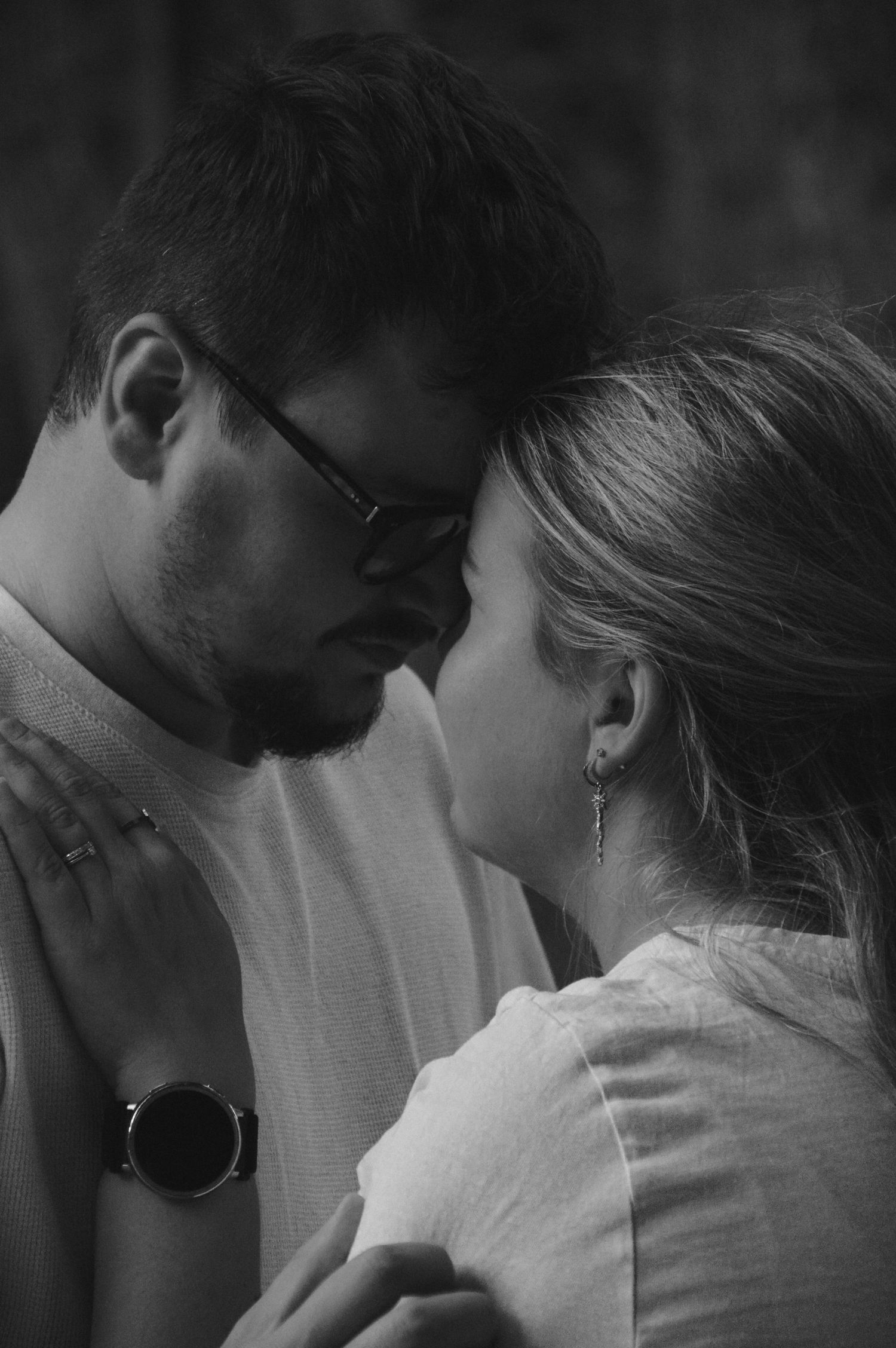 Intimate black and white portrait sequence showing tender moments between two people.