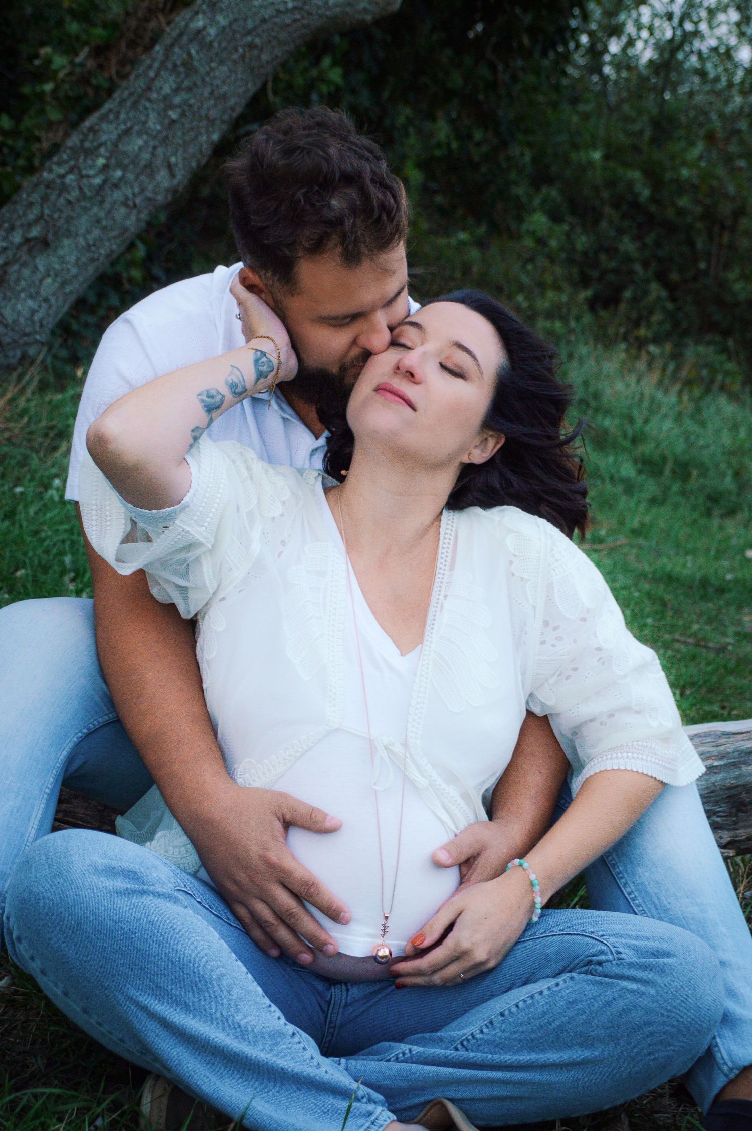 Tender maternity moments photographed in casual outdoor setting.