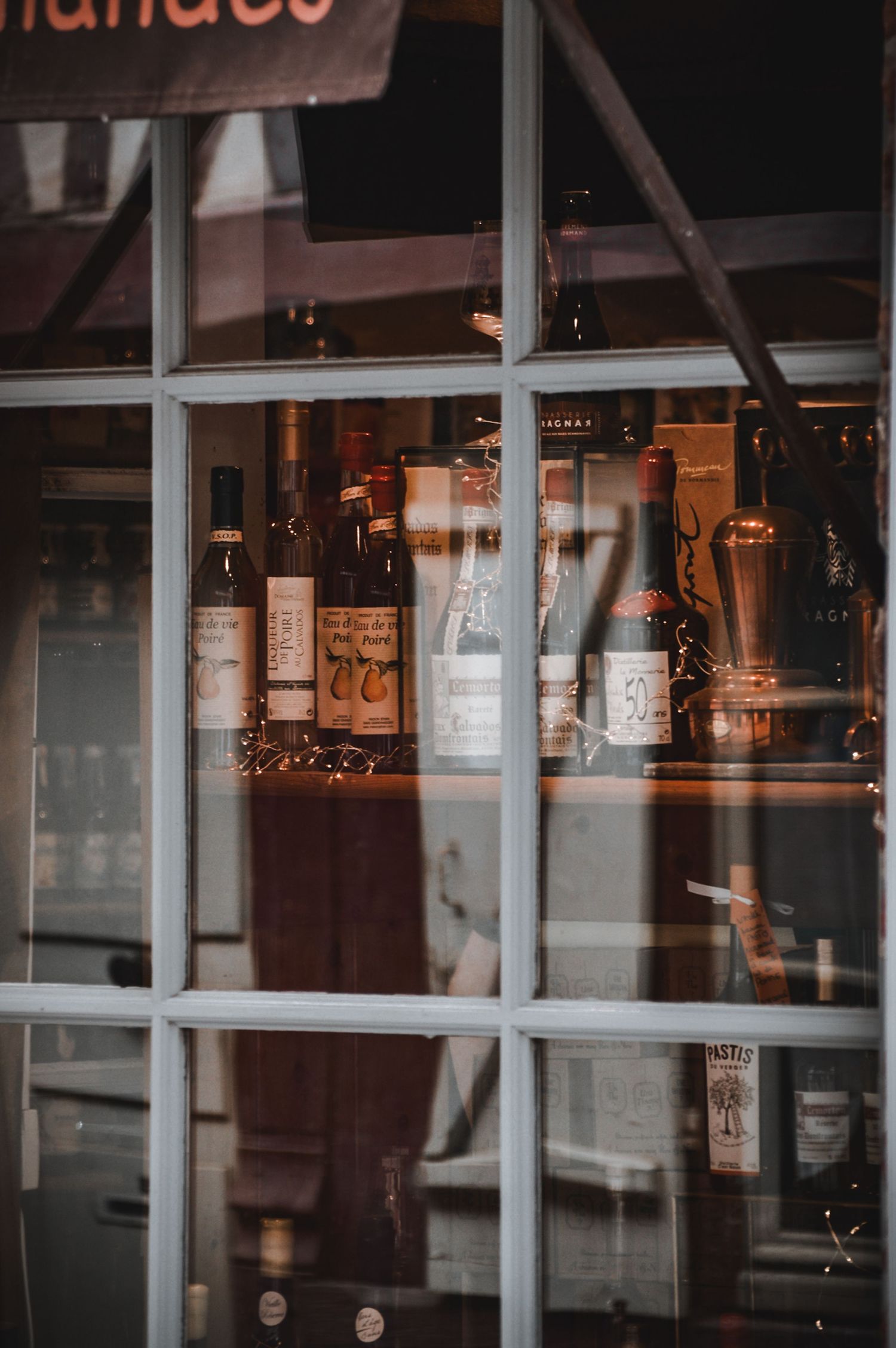 Reflective storefront windows with dim lighting and urban ambiance in evening setting.