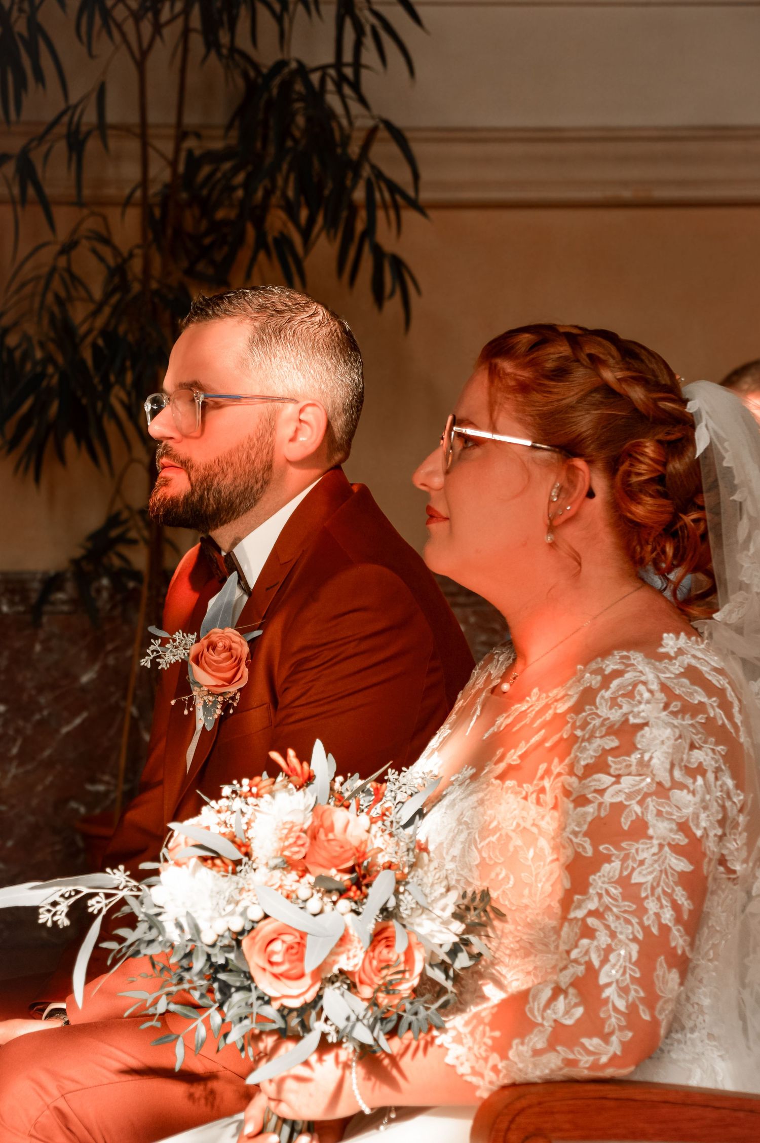 Wedding reception candid moments captured in warm indoor lighting with floral decorations.