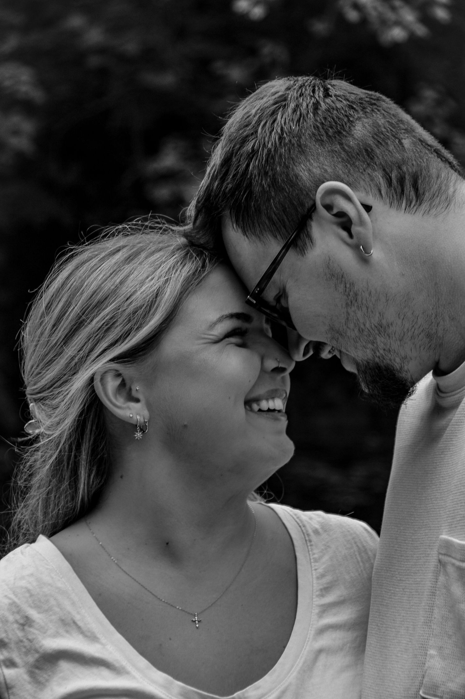 Intimate black and white portrait series showing tender moments between a couple.