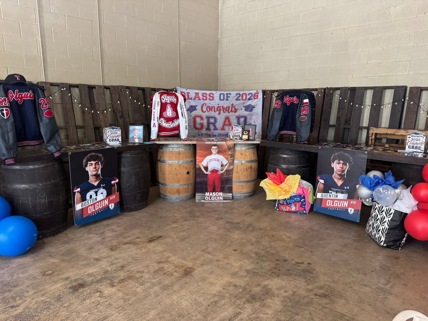 Class of 2024 graduation party with photo banners, barrels, and colorful balloons at Josabi's Acres in Helotes, TX.