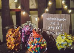 Wedding candy bar with sweets in glass jars and a rustic sign reading Love Is Sweet Please Take a Treat at Josabi's Acres in Helotes, Texas