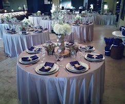 Elegant wedding reception tables with silver linens, navy napkins, white floral centerpieces at Josabi's Acres in Helotes, Texas