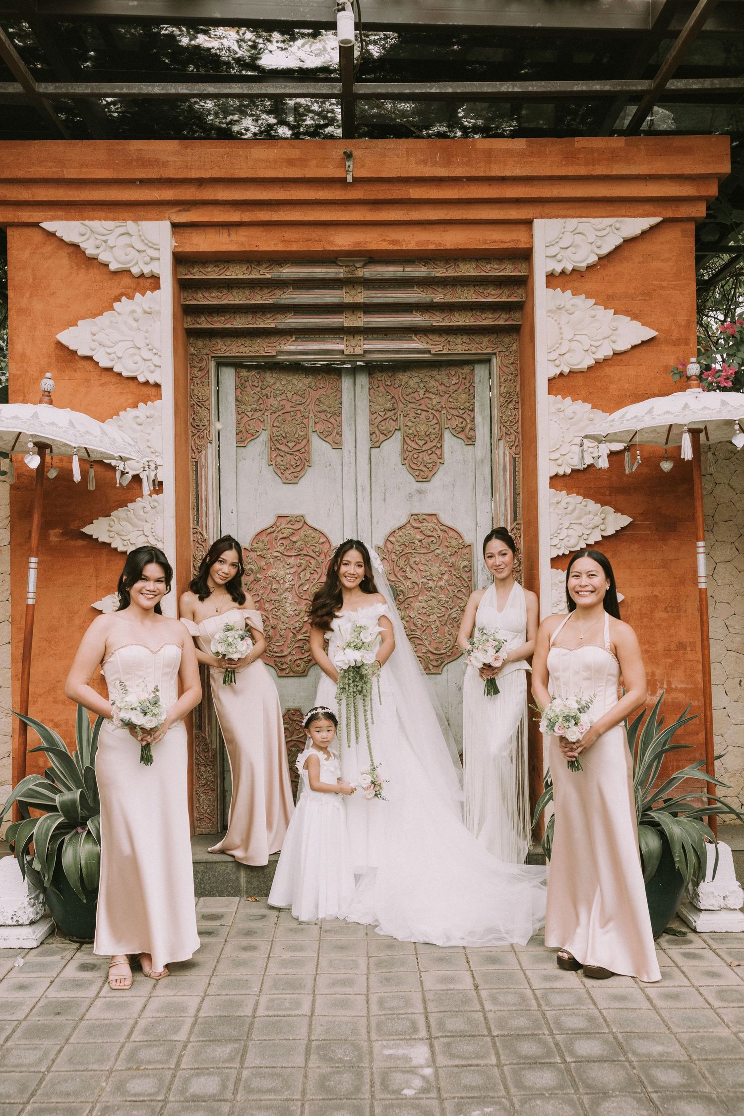 Bride and bridesmaids sharing a joyful moment at a Bali wedding.