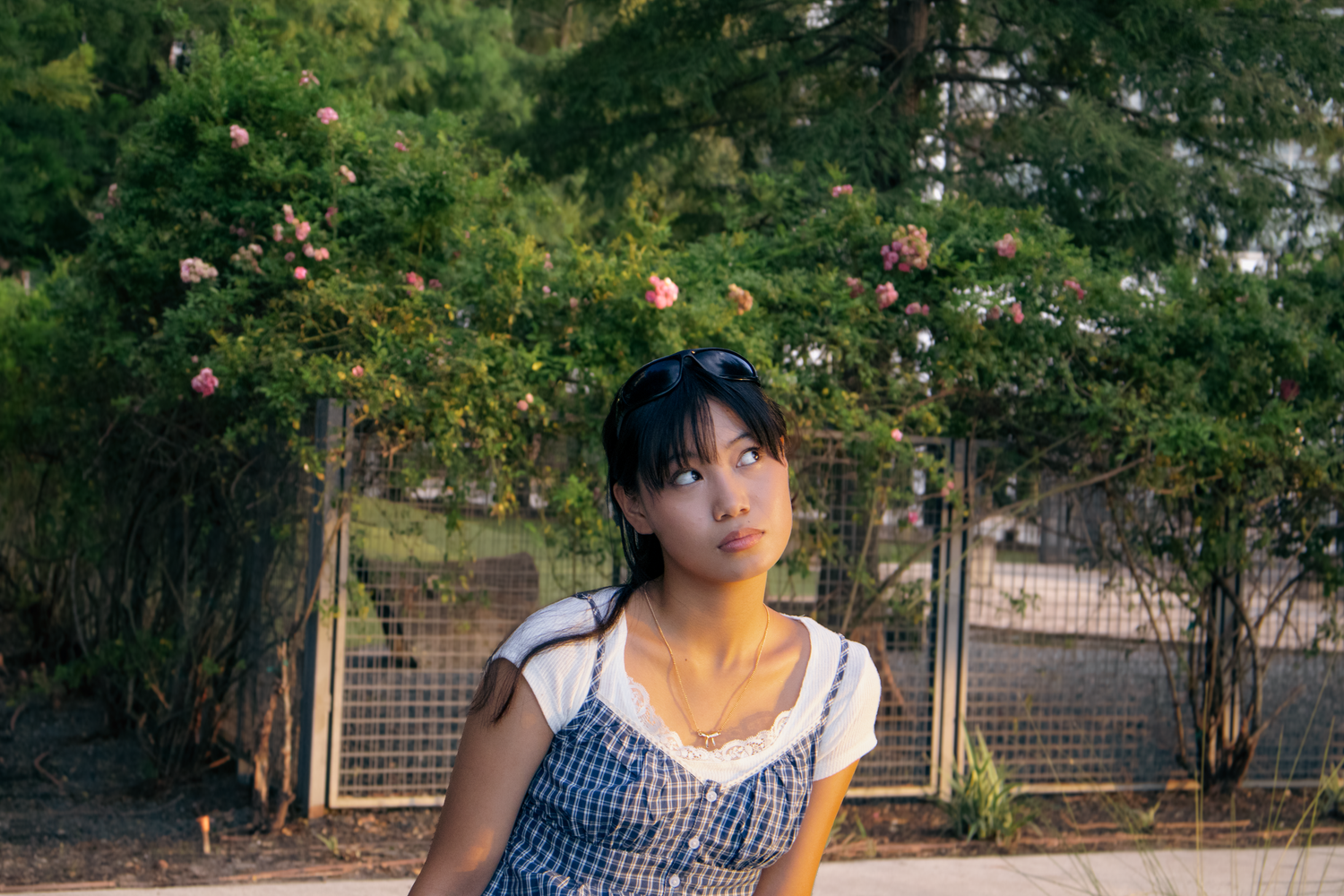 Girl sitting with flowers behind her