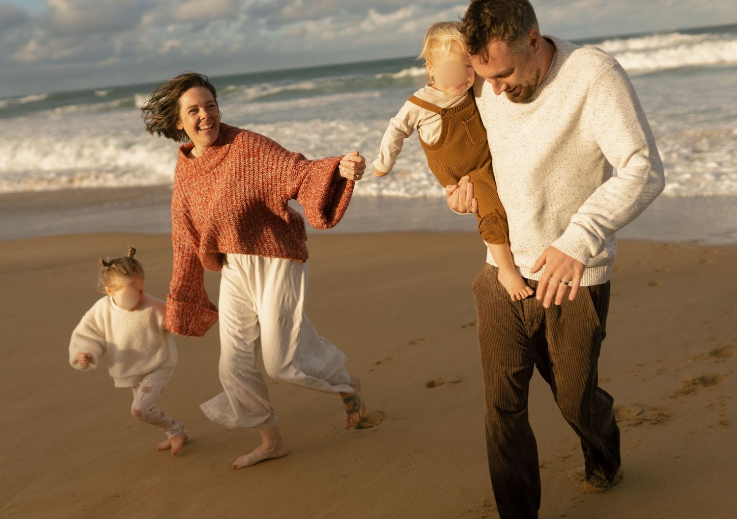 Family running by the ocean at a Sunshine Coast beach family mini session at Warana Beach