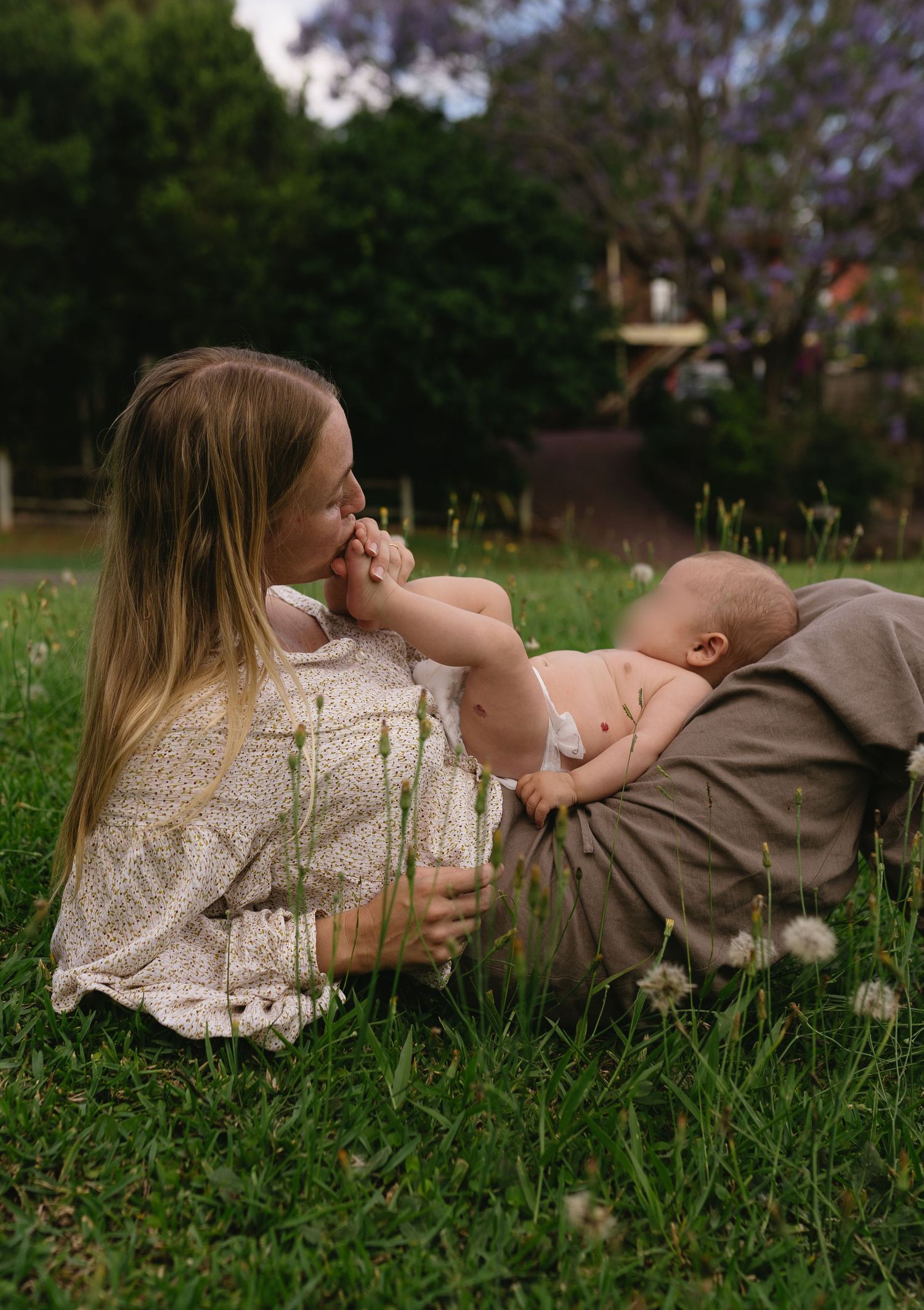 Mum kissing her baby while enjoying the quiet moments of early motherhood