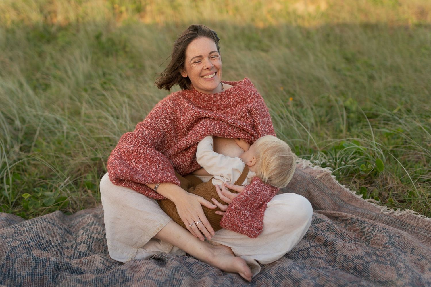 Documentary-style breastfeeding photography capturing connection and togetherness in nature