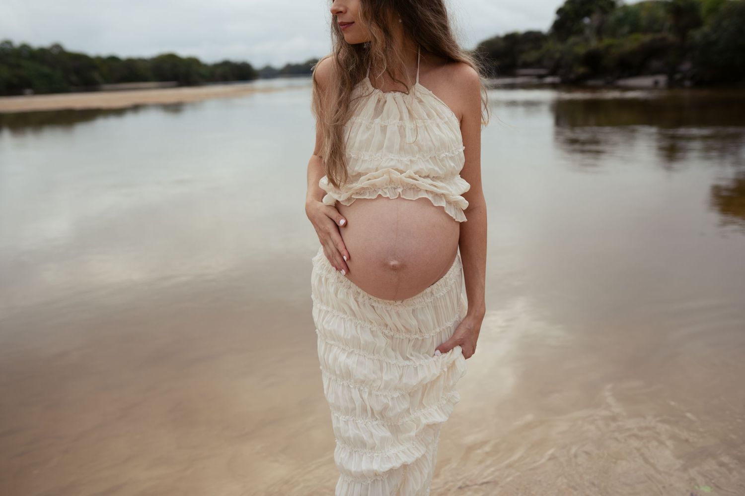 Expecting mother walking along the beach during a Sunshine Coast maternity photography session