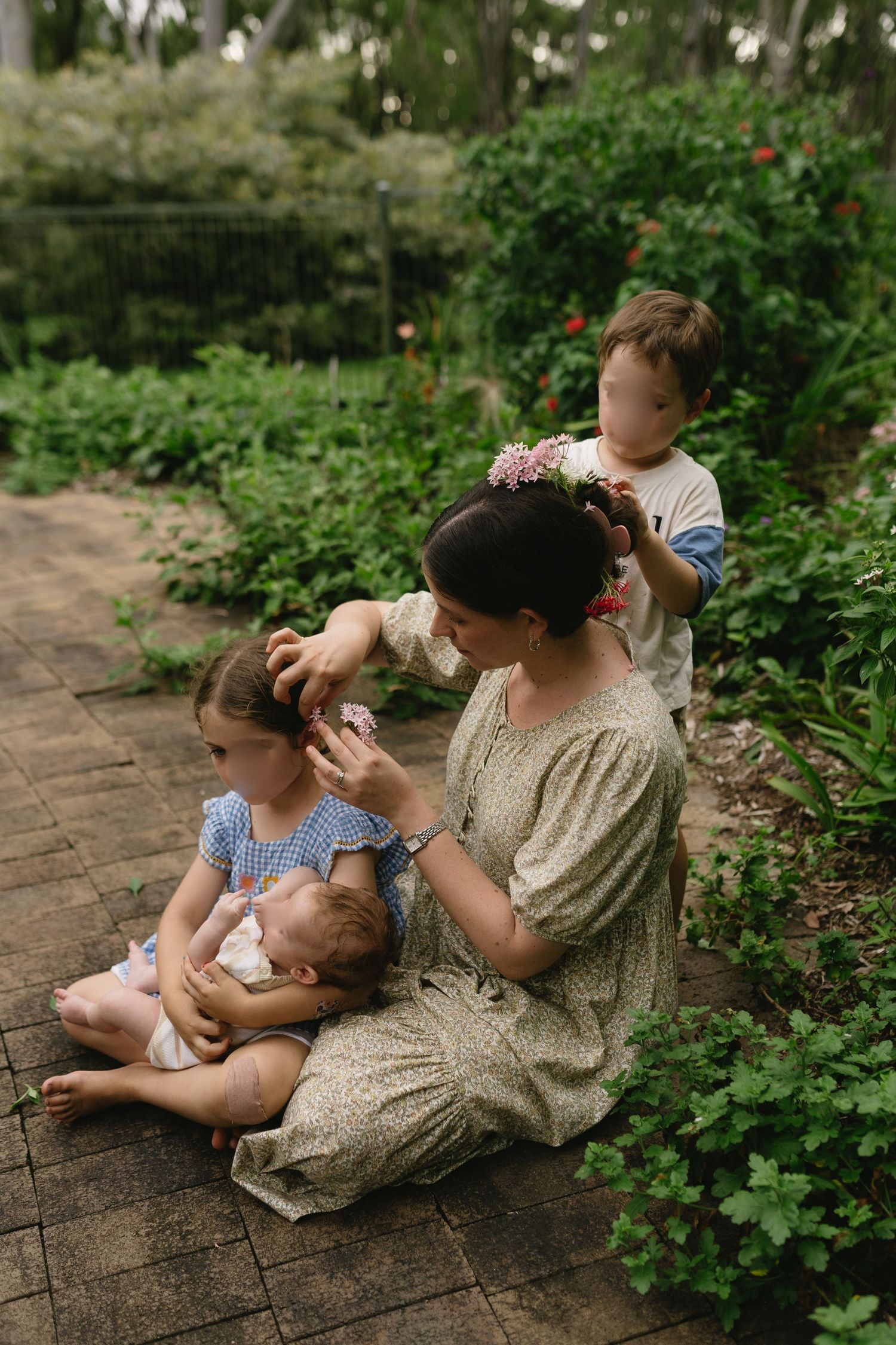 Toddler placing flowers in their mother’s hair during a playful motherhood moment