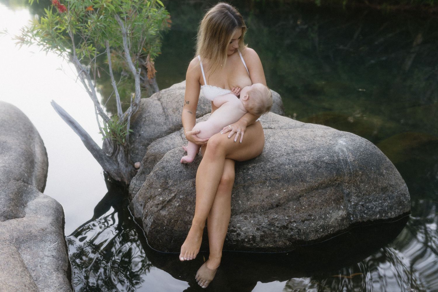 Quiet breastfeeding moment between mother and baby outdoors