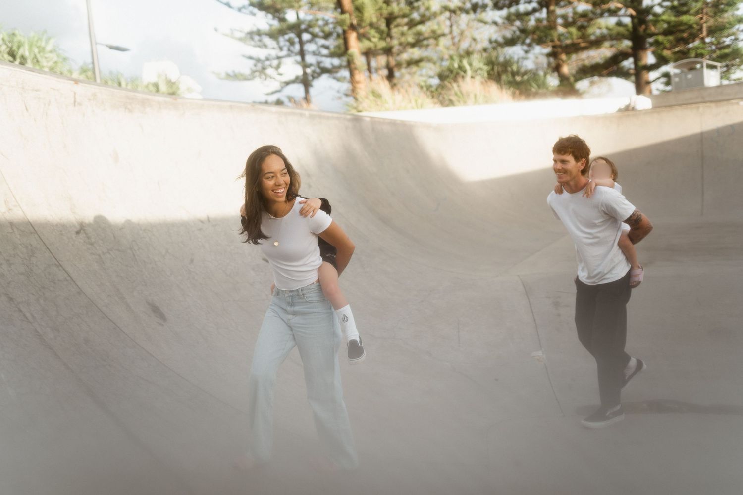 Family playing together outdoors during a natural lifestyle photo session