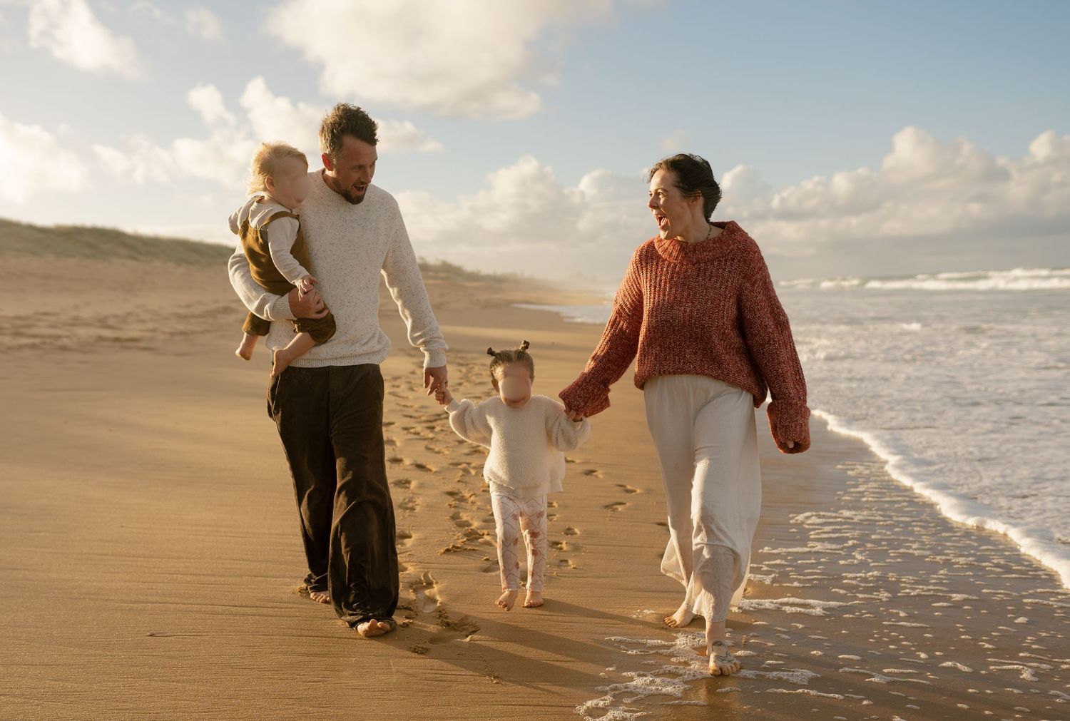 Family of four playing together on the beach during a Warana Beach Mini photography session