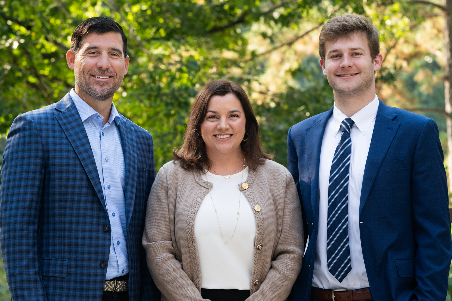Professional team headshot of three business professionals photographed outdoors in Fayetteville, NC
