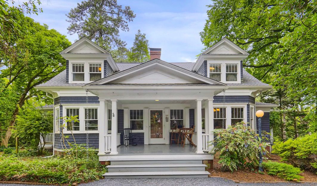 Exterior view of a white modern farmhouse style home with dormer windows in Pinehurst NC by a professional photographer in Fayetteville NC