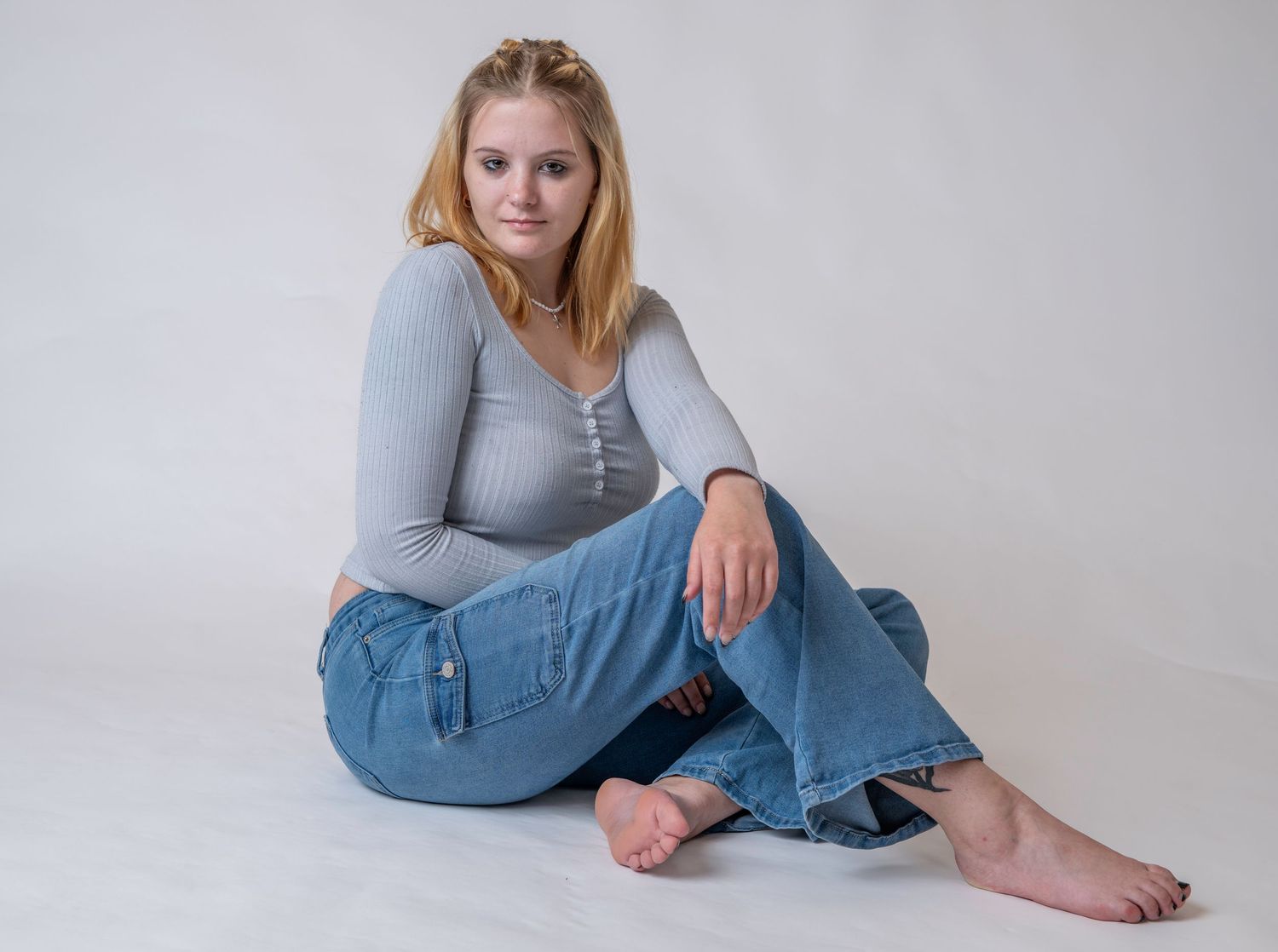 Studio portrait of a woman against a neutral gray background