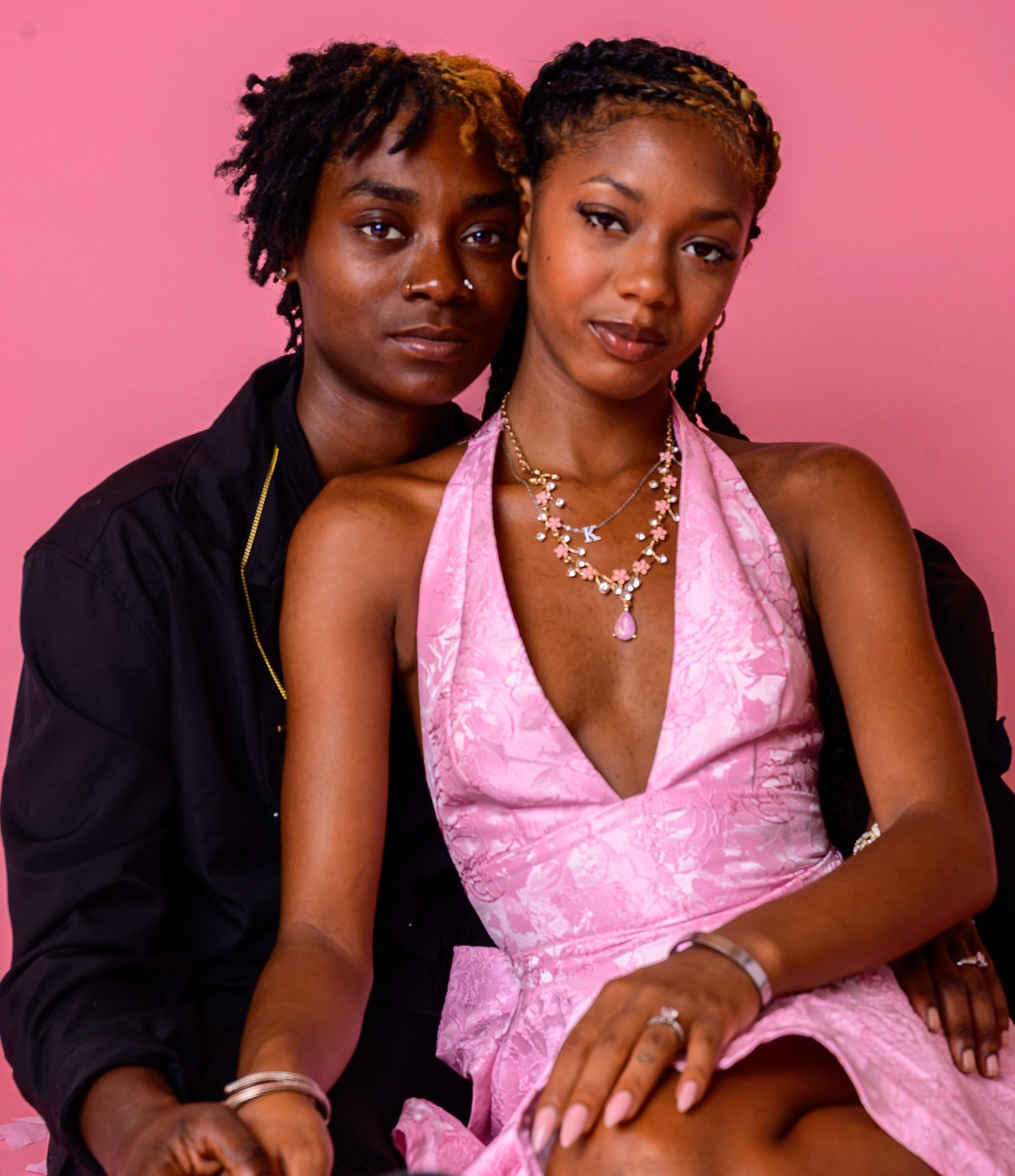 Creative milestone portrait of two women against a pink studio background in the D2lifephotography studios, Fayetteville, NC